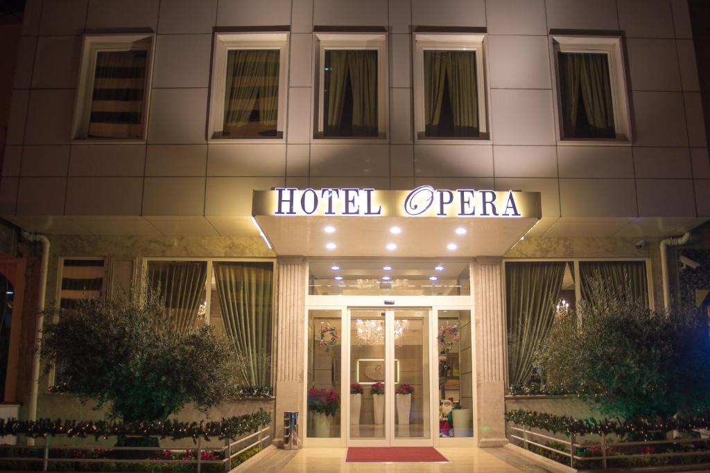 ein Hotel-offenes Schild auf der Vorderseite eines Gebäudes in der Unterkunft Hotel Opera in Tirana