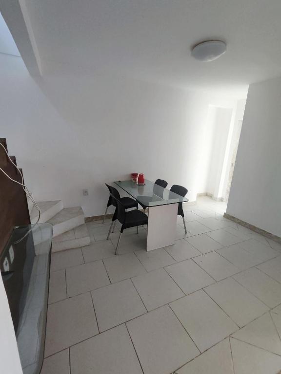 a white room with a table and chairs in it at Village Beira mar in Lauro de Freitas