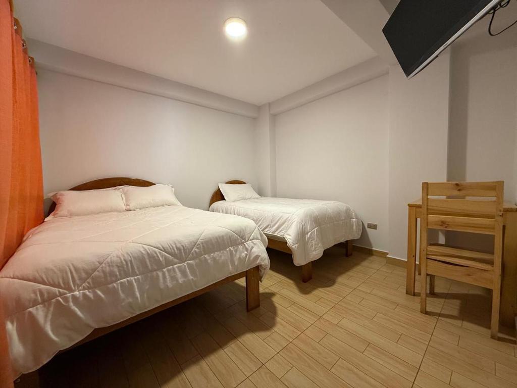 Postel nebo postele na pokoji v ubytování cusco terra inn