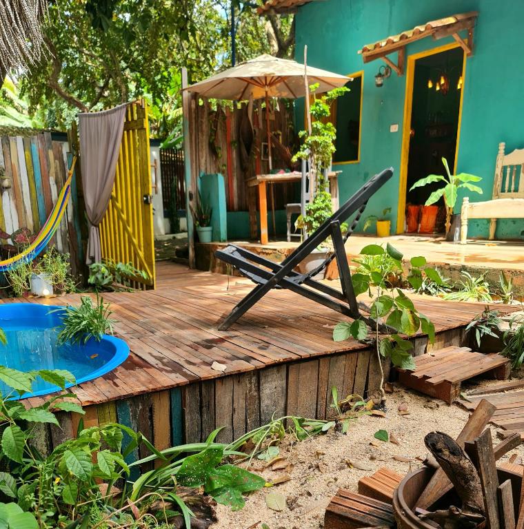 a wooden deck with a hammock and a house at Casinha Aconchegante em Alter do Chão 2min da ilha in Alter do Chao