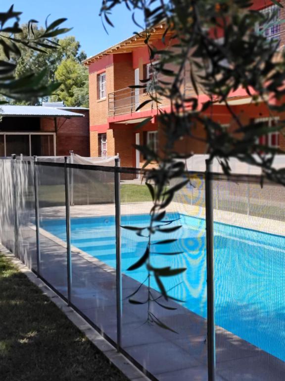 a fence next to a swimming pool at Los Olivos Apart in San Rafael