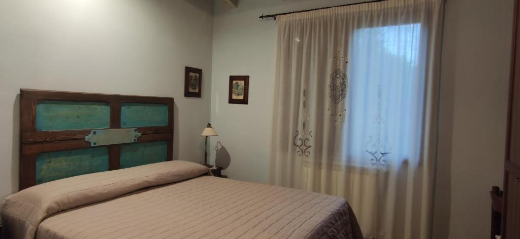 Postel nebo postele na pokoji v ubytování B&B Della Via Francigena