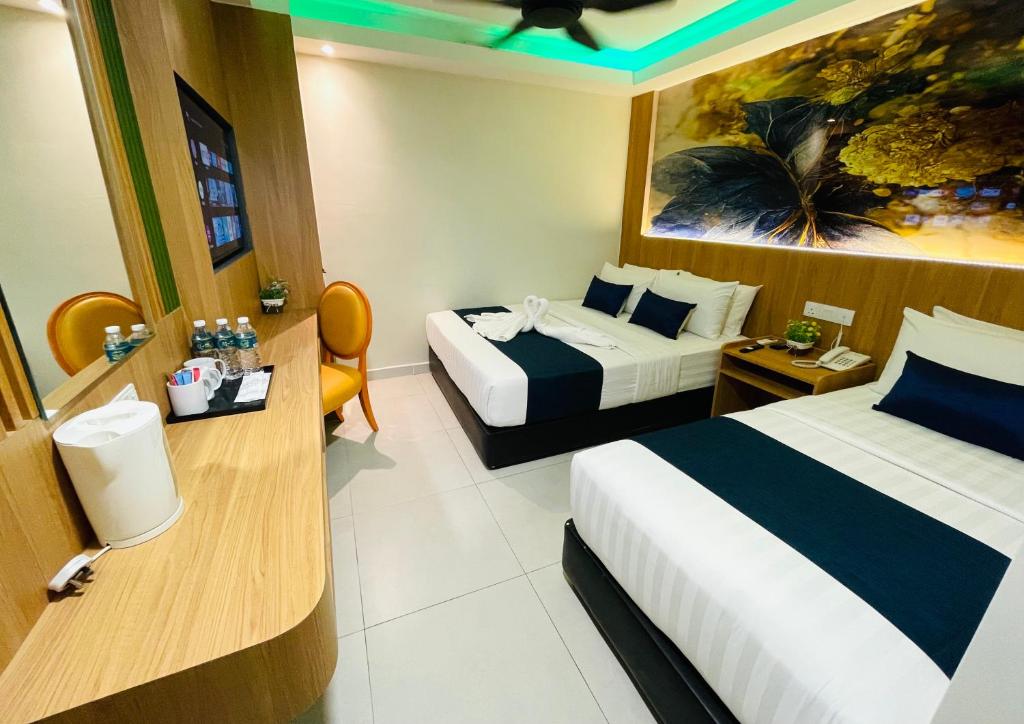 A two-bed room with a long refreshment counter, two orange chairs and colorful ceiling lighting.