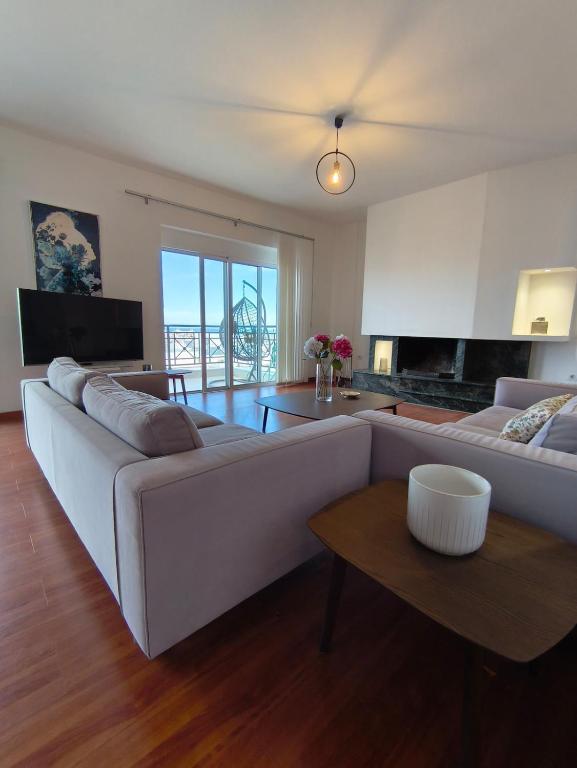 a living room with a white couch and a table at Downtown Luxury Apartment in Rhodes Town