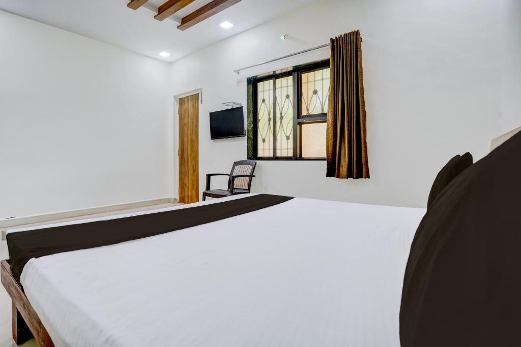 Postel nebo postele na pokoji v ubytování Hotel O Shree Prabhat