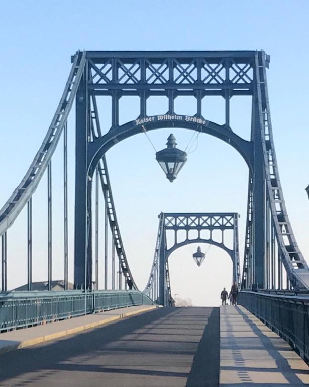 a bridge with two people walking on it at Nordsee in Wilhelmshaven