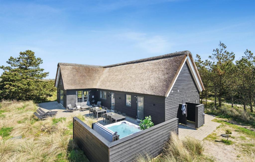 a house with a swimming pool in the backyard at Amazing Home In Henne With Kitchen in Henne Strand