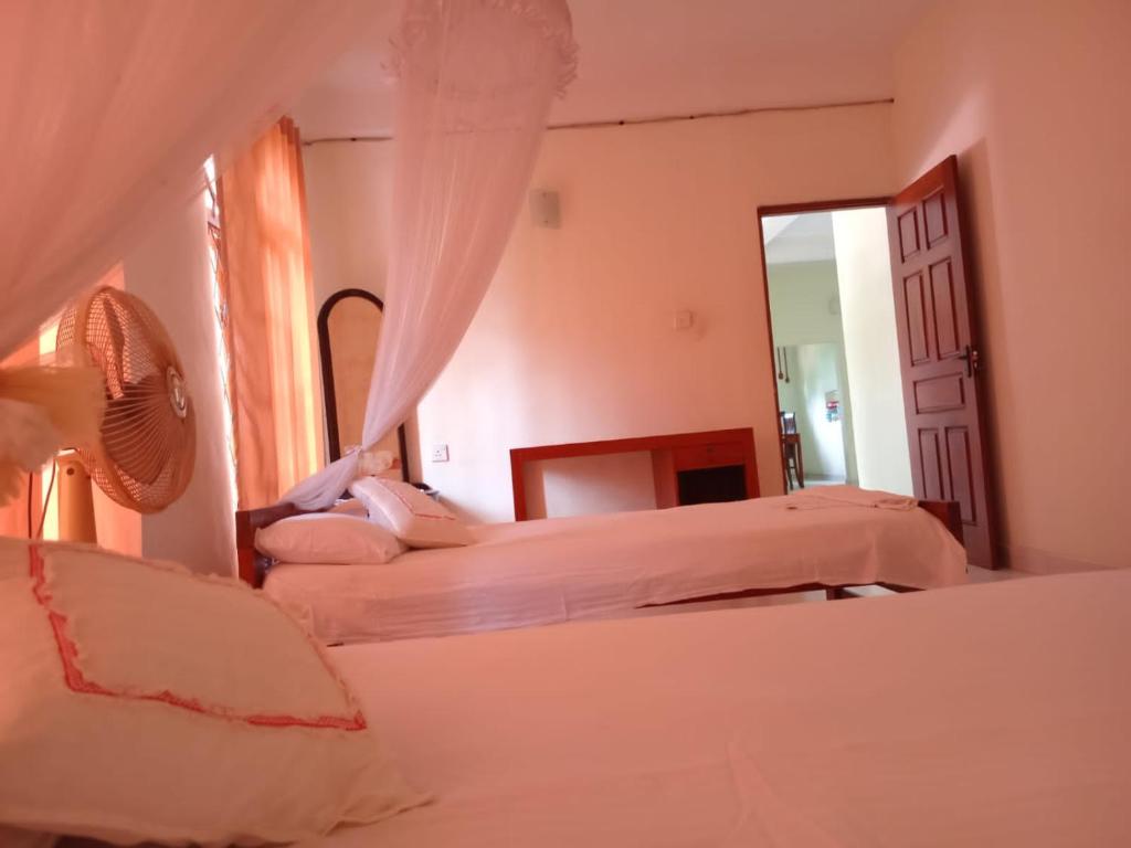 Postel nebo postele na pokoji v ubytování Ajanthas' Homestay