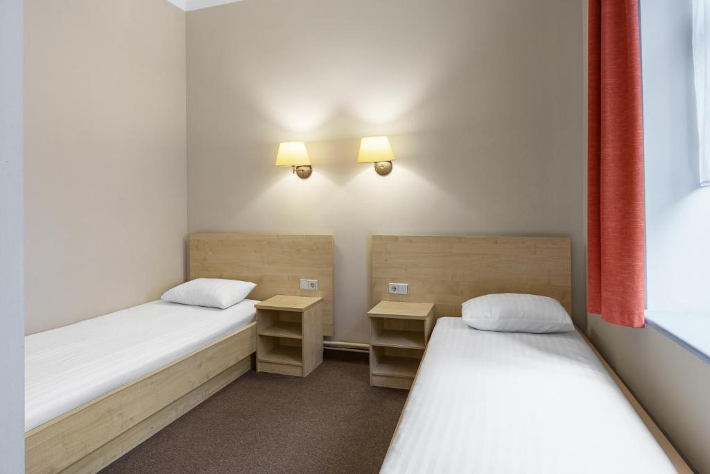 Postel nebo postele na pokoji v ubytování Rija Domus Hotel