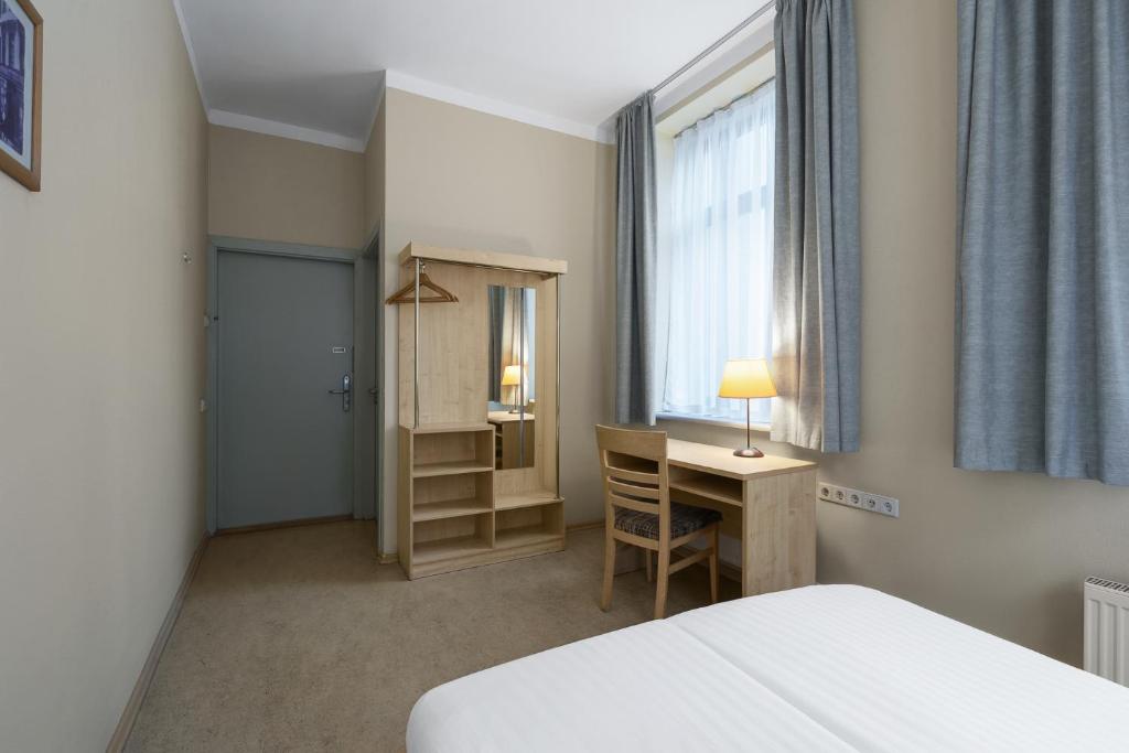 Postel nebo postele na pokoji v ubytování Rija Domus Hotel