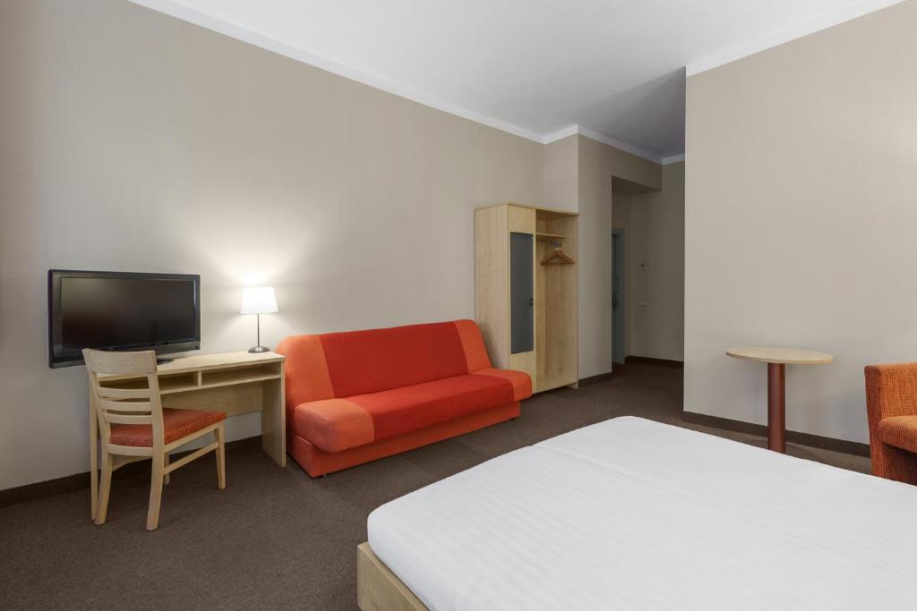 TV a/nebo společenská místnost v ubytování Rija Domus Hotel