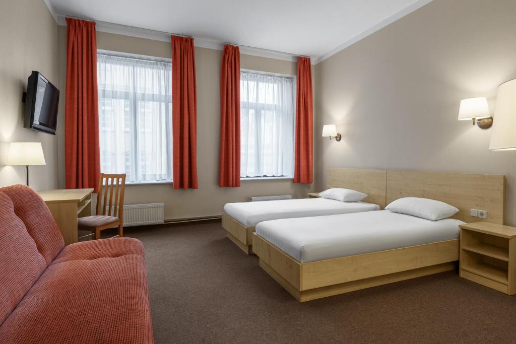 Postel nebo postele na pokoji v ubytování Rija Domus Hotel