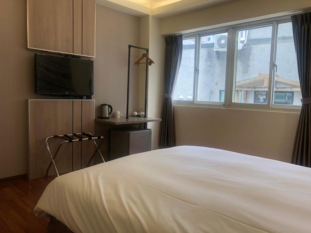Postel nebo postele na pokoji v ubytování 天璽商務飯店 Cullinan Hotel