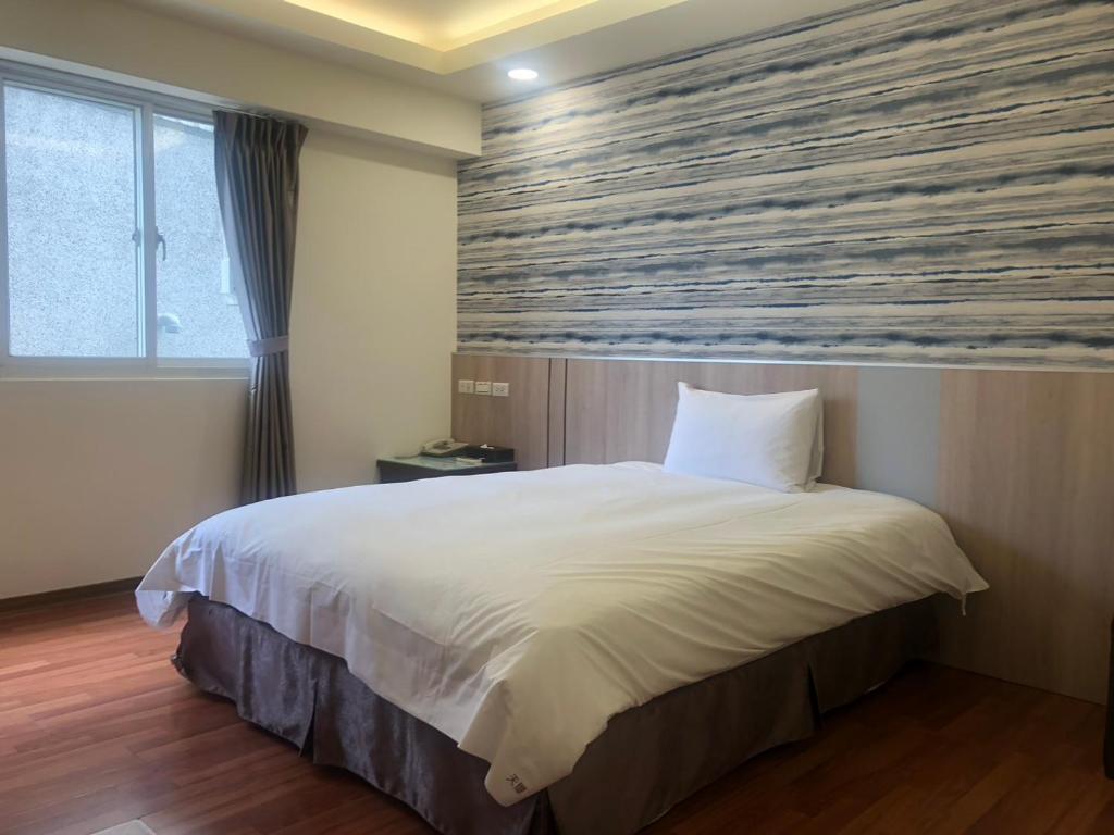 Postel nebo postele na pokoji v ubytování 天璽商務飯店 Cullinan Hotel