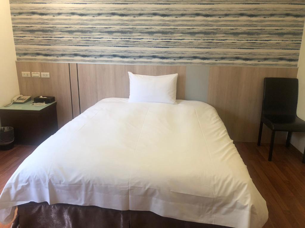 Postel nebo postele na pokoji v ubytování 天璽商務飯店 Cullinan Hotel