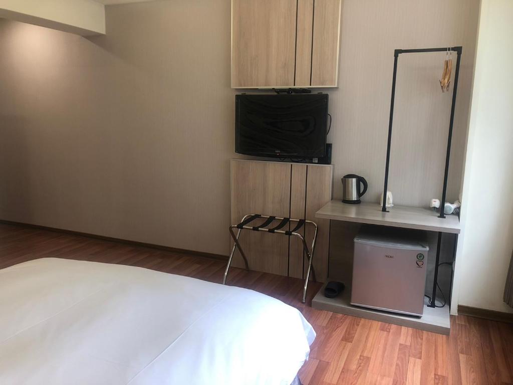 Postel nebo postele na pokoji v ubytování 天璽商務飯店 Cullinan Hotel