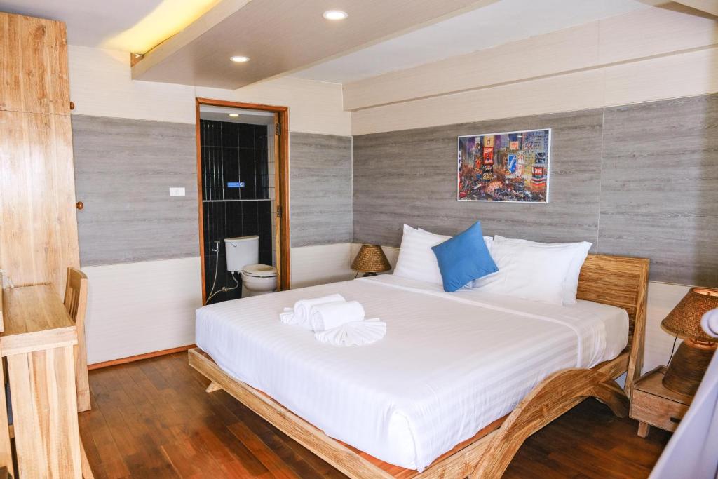 a bedroom with a large white bed in a room at GOYA hotel in Chiang Mai