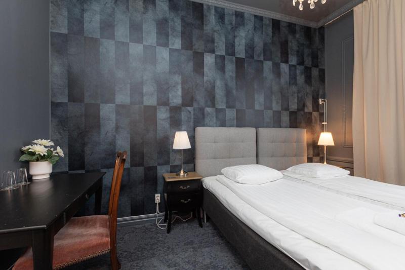 Postel nebo postele na pokoji v ubytování Hotell Drottninggatan 11