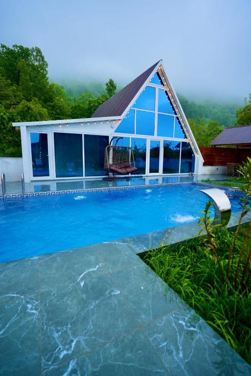 a house with a swimming pool with a house at 3Gozel Aframe Villa Gabala in Gabala