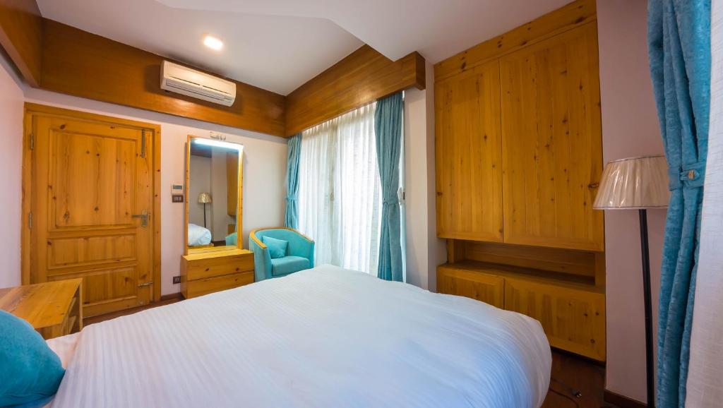 Postel nebo postele na pokoji v ubytování Lalit Service Apartment