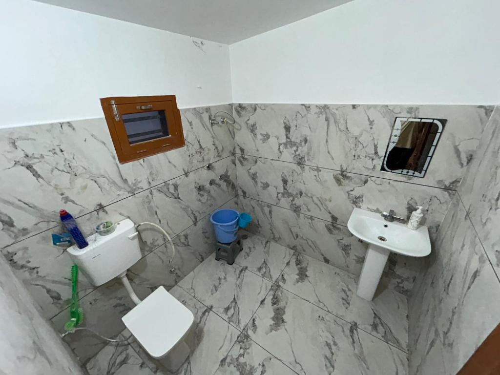 a bathroom with a sink and a toilet at Dhawanfarms in Bela