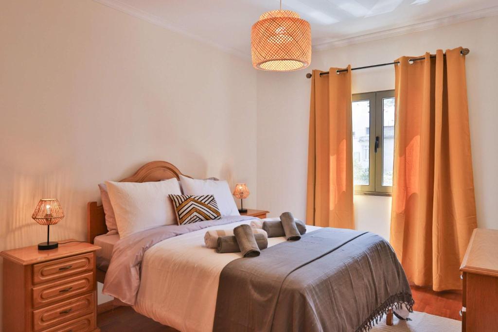 a bedroom with a bed with two teddy bears on it at Apartamento Janela do Atlantico in Machico