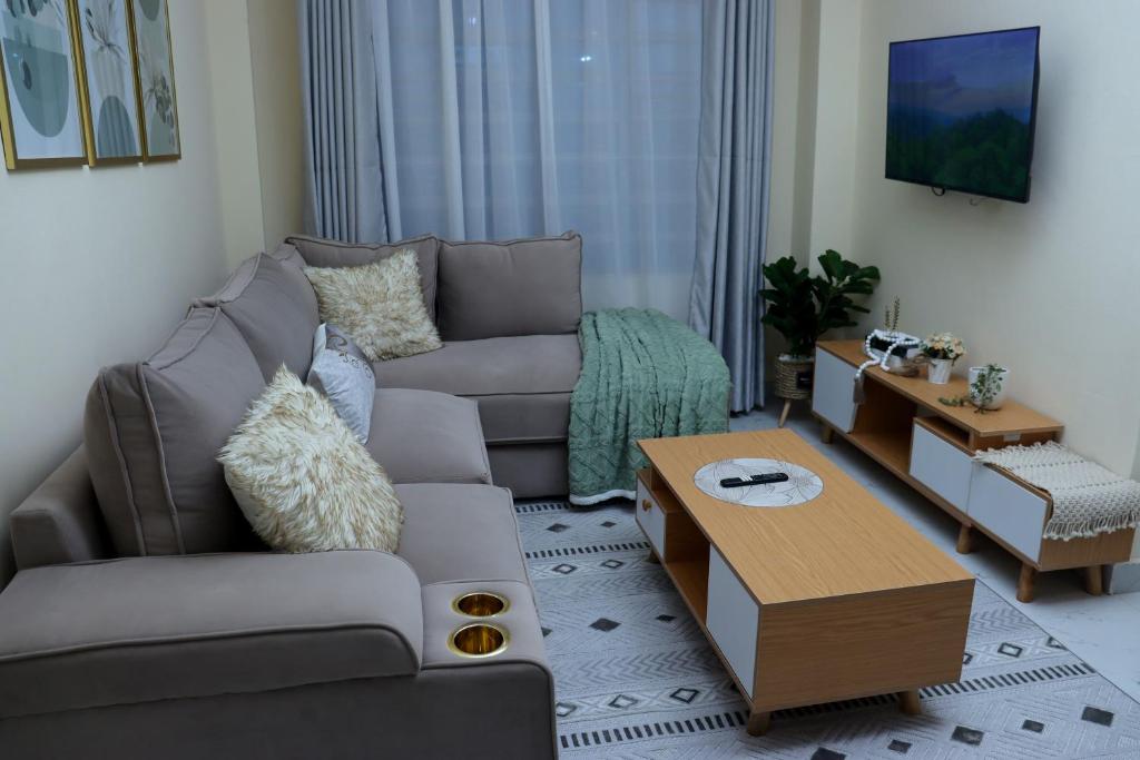 a living room with a couch and a coffee table at The Nordic Nest in Ruiru