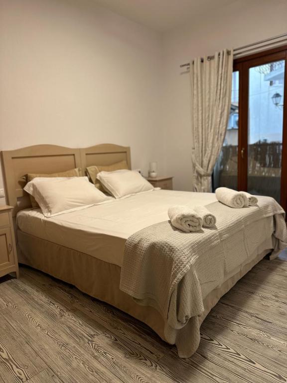 a bedroom with a bed with two towels on it at Spiti Skiathos town in Skiathos