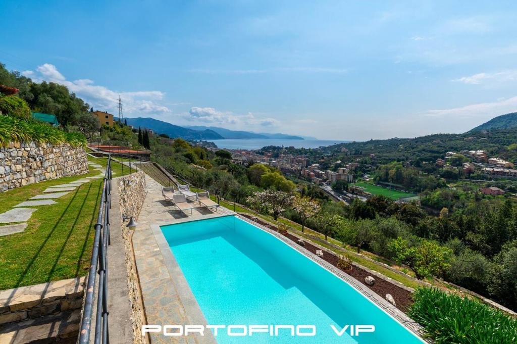 a villa with a swimming pool on a hill at Suite Ulivo by Villa Melograno, Pool, AC, Parking in Santa Margherita Ligure