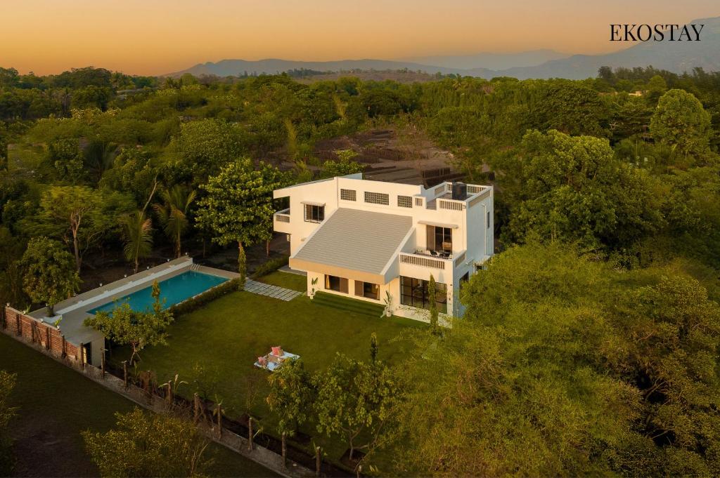 an aerial view of a house with a swimming pool at EKOSTAY - White Lotus in Karjat