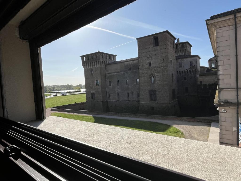 a view of a castle from a window at Castle Charm Apartment, MantegnaHotels in Mantova