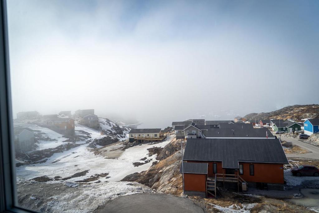 a group of houses on top of a mountain at HOTEL SØMA Ilulissat in Ilulissat
