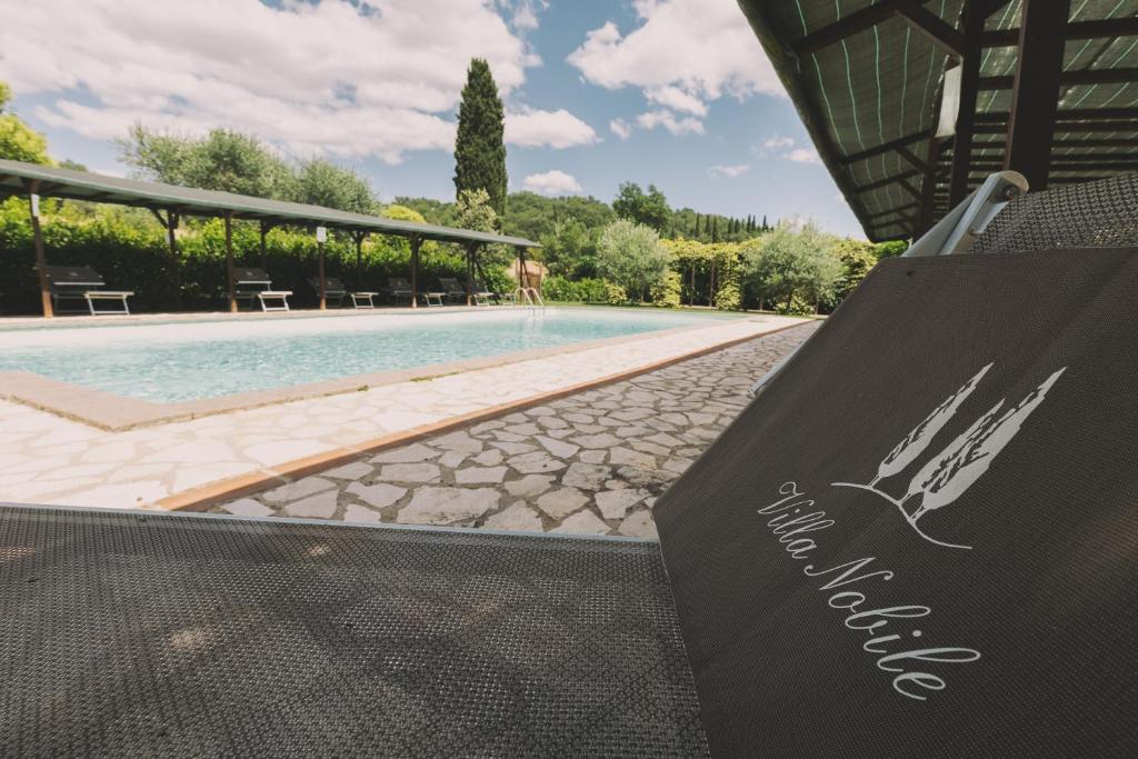 a sign in front of a swimming pool at Villa Nobile Cortona in Cortona
