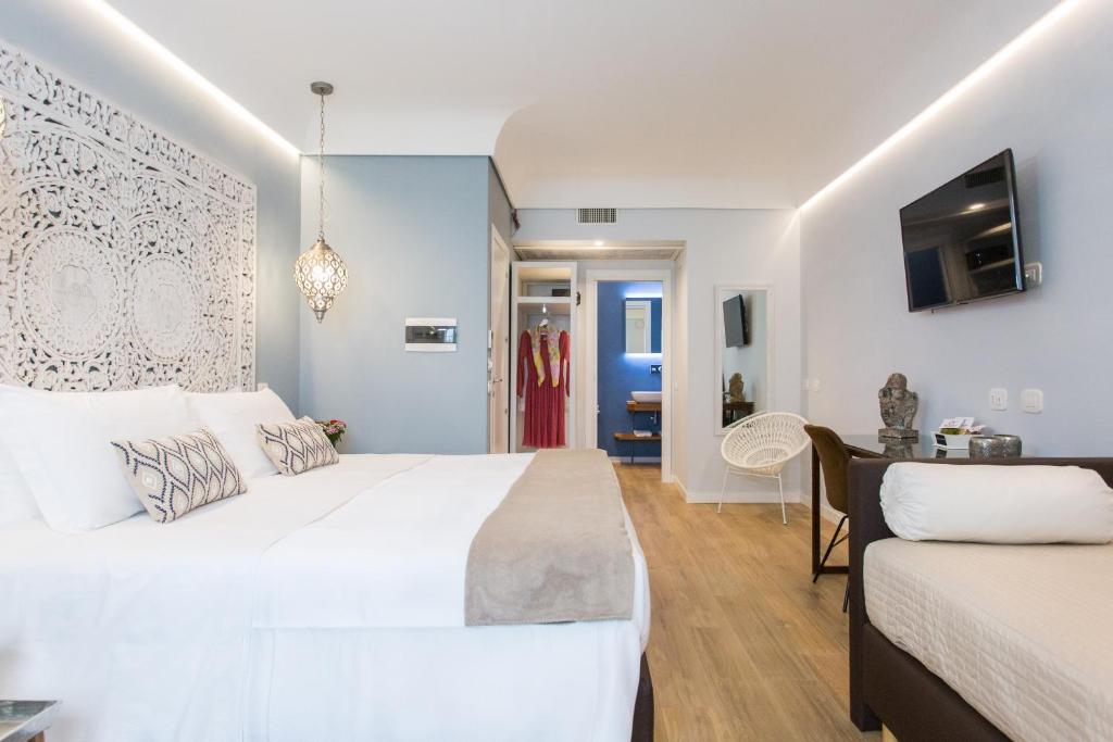 Una cama o camas en una habitación de Bellaroto Suite & SPA