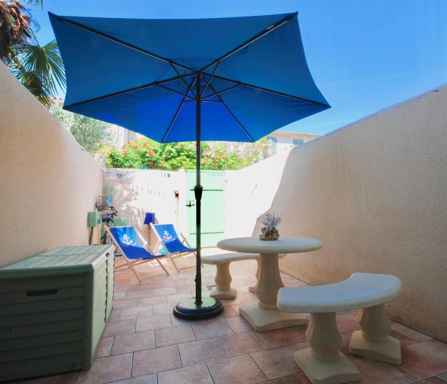 - une table, 2 chaises et un parasol sur la terrasse dans l'établissement 130 Les gouverneurs 19, à Saint-Martin-de-Ré
