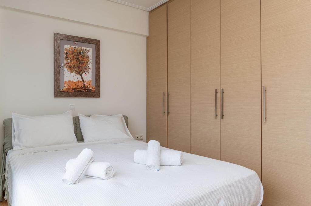 A bed or beds in a room at Elvita Athens Sea View Maisonette