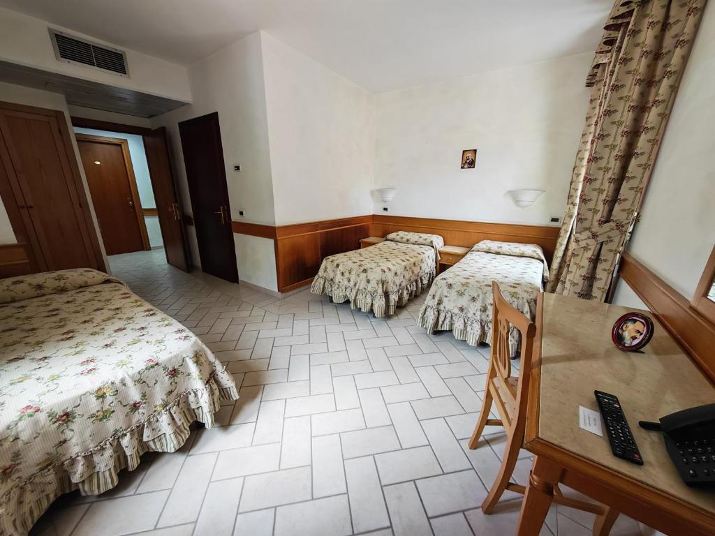 Postel nebo postele na pokoji v ubytování Hotel Pace