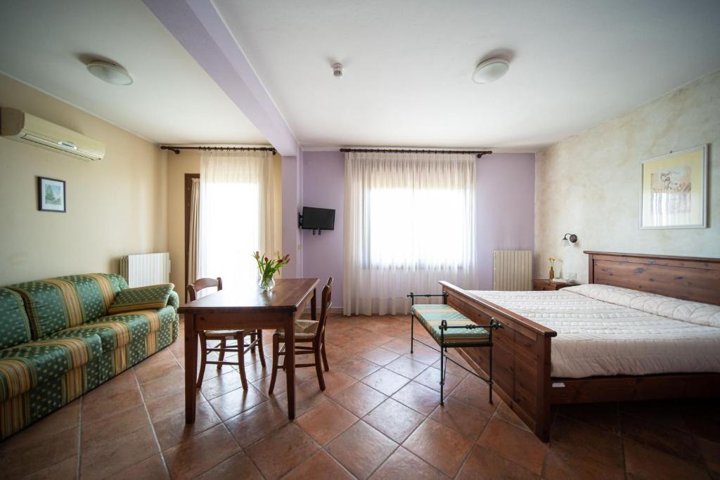 Postel nebo postele na pokoji v ubytování Agriturismo San Bartolomeo