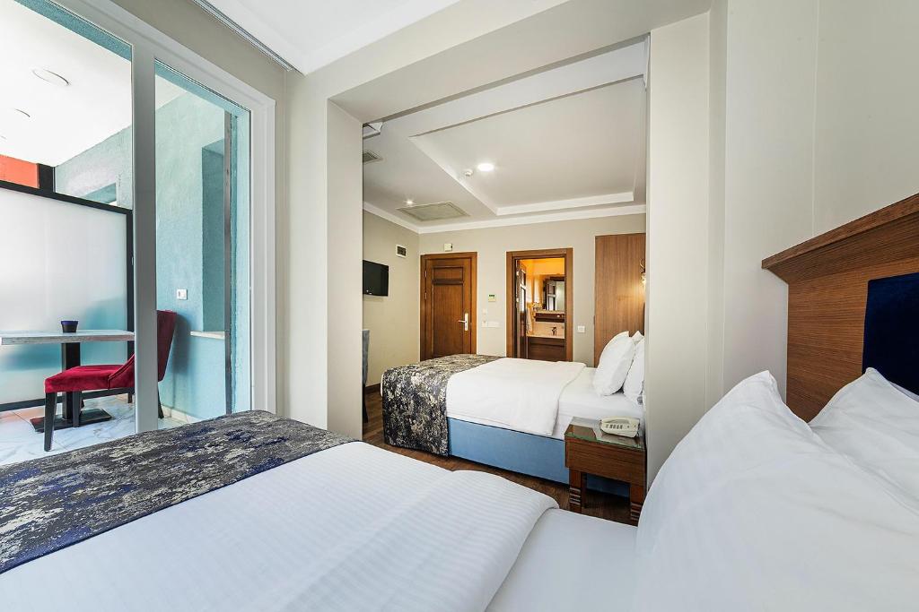A bed or beds in a room at Aristocrat Hotel