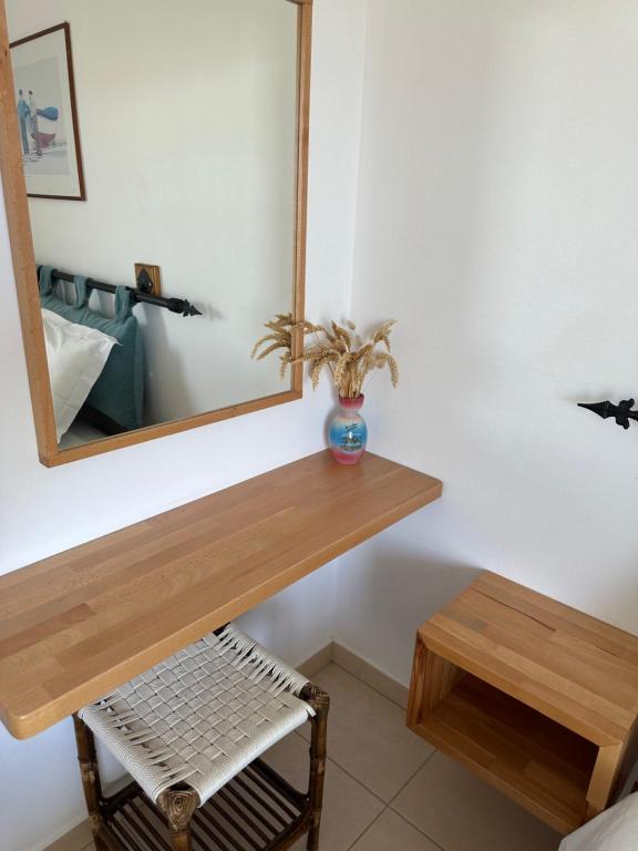 a bathroom with a wooden counter and a mirror at ELÉA Guesthouse himare in Himare