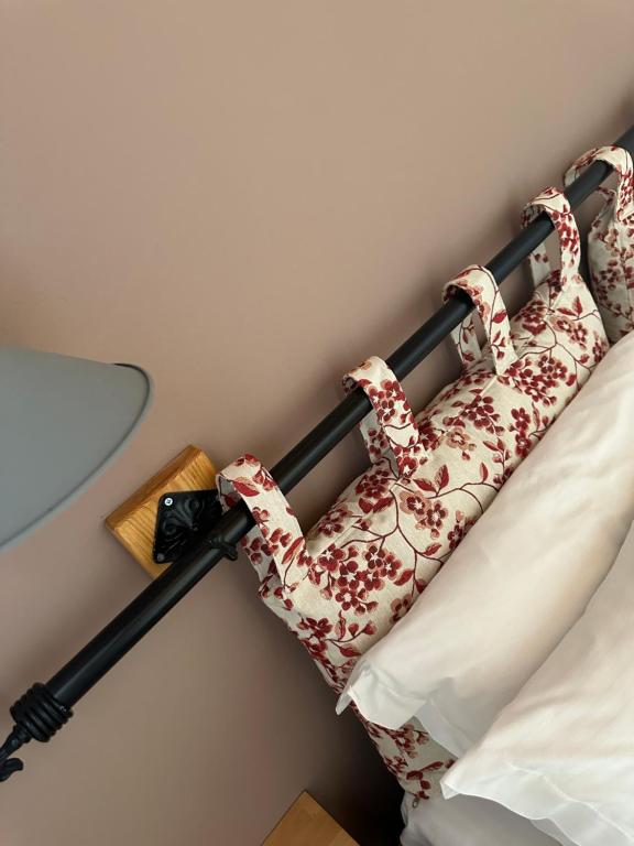 a headboard of a bed in a room at ELÉA Guesthouse himare in Himare