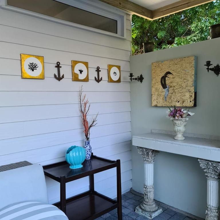 a porch with a bench and a table at Gingerbread Man's Cottage in Sedgefield