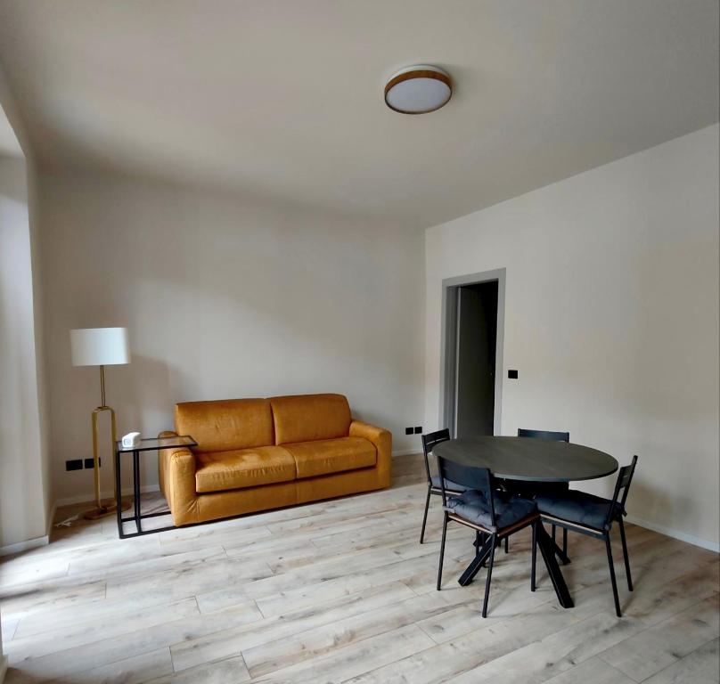 a living room with a couch and a table at La Morra Apartments in La Morra