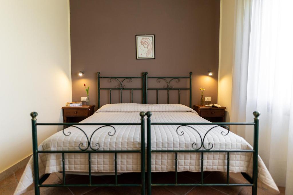 Postel nebo postele na pokoji v ubytování Agriturismo San Bartolomeo
