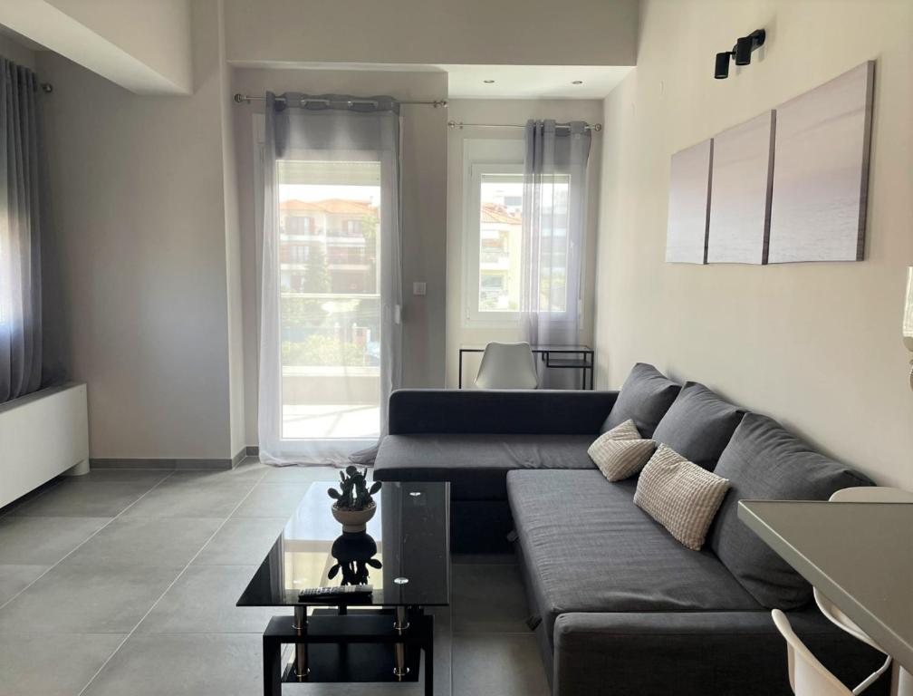a living room with a couch and a table at Panorama Sunvilles Apartment 5 in Thessaloniki