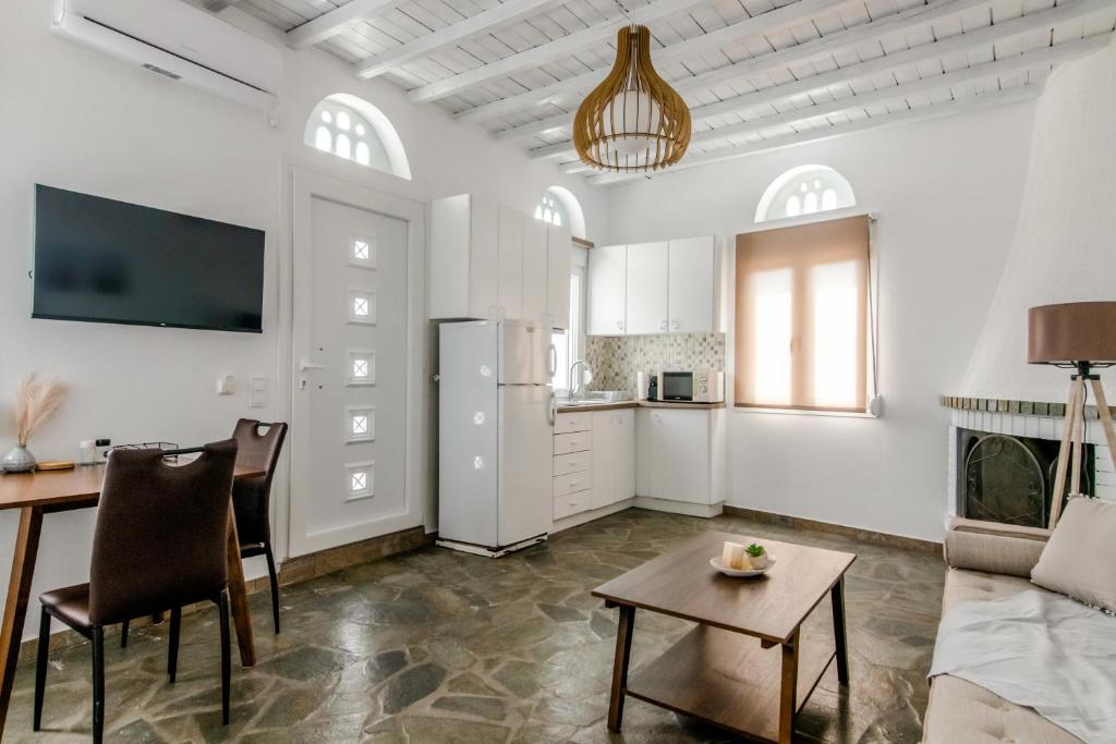 a living room with a couch and a table at Harmony Apartment 2 in Agios Sostis