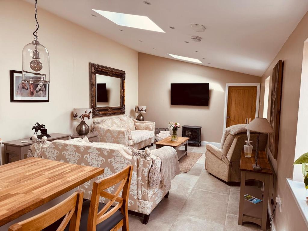 a living room with a couch and a table at The Forge, Newly Converted Barn in Carnforth