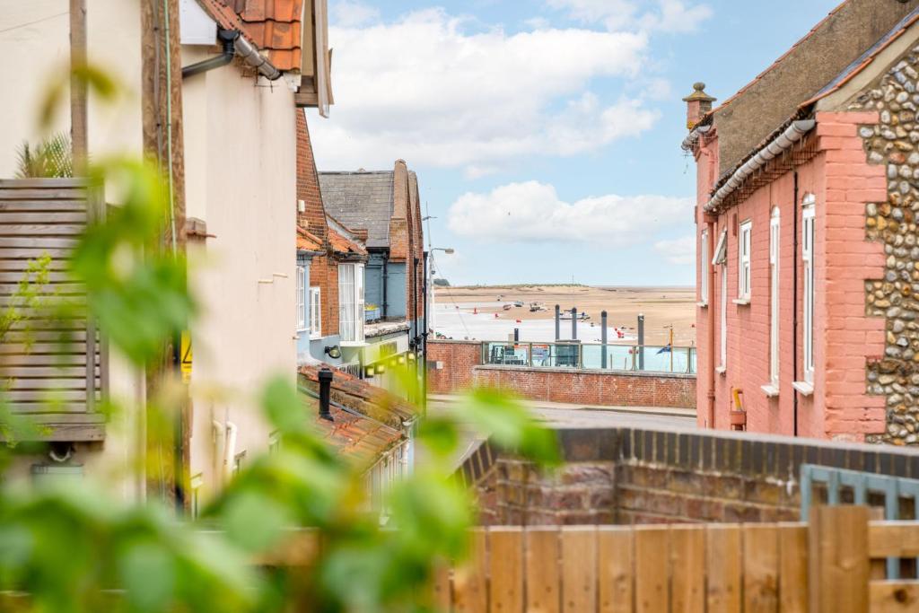a view of a street with buildings and the beach at Kipling House 8 in Wells next the Sea
