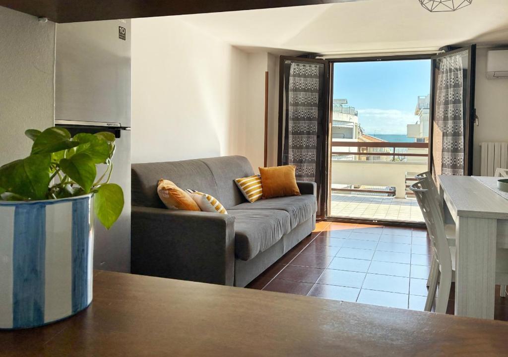 a living room with a couch and a table at Holihome MENTANA FRN in Alba Adriatica