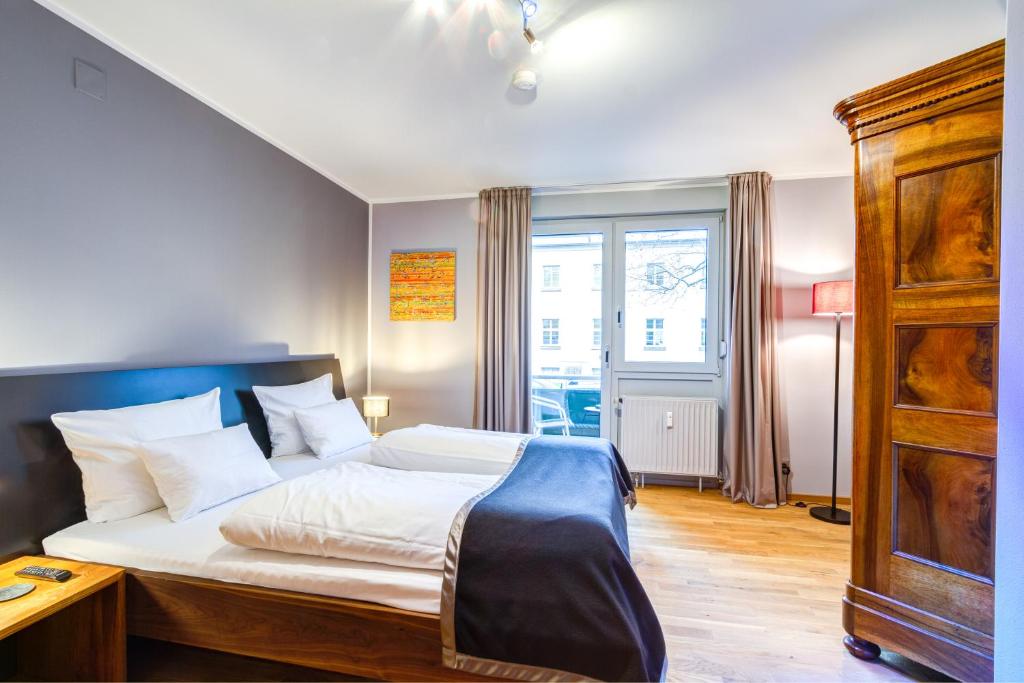Postel nebo postele na pokoji v ubytování Qube Hotel Bergheim